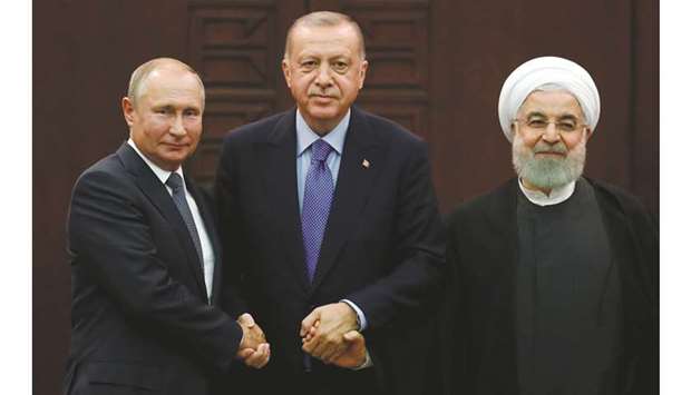 Presidents Vladimir Putin of Russia, Recep Tayyip Erdogan of Turkey and Hassan Rouhani of Iran pose following a joint news conference in Ankara, yesterday.