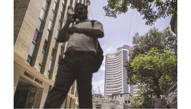 A pedestrian walks near the Bombay Stock Exchange building in Mumbai (file). While Indian Prime Minister Narendra Modi isnu2019t sitting idly by as the economy weakens, investors say heu2019s been slow to act on a long list of needed reforms that includes selling stakes in state-owned companies and revamping the nationu2019s labour laws. Many of Indiau2019s problems pre-date Modi, but critics say his handling of the economy has been disappointing.