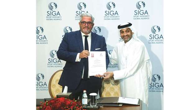 Qatar Stars League CEO Hani Taleb Ballan (right) and SIGAu2019s CEO Emanuel Macedo de Medeiros pose after signing a agreement.