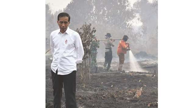 Indonesian President Joko Widodo inspecting the damages from the ongoing forest fires in Pekanbaru yesterday.