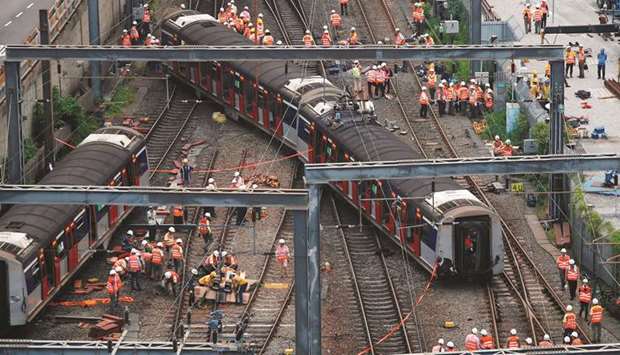 A Mass Transit Railway (MTR) train is seen derailed on the East Rail line in Hong Kong, China, yesterday.