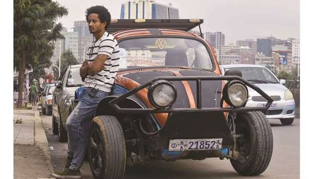 Ethiopian painter Robel Wolde poses in front of his u2018pimpedu2019 Volkswagen Beetle in Addis Ababa.