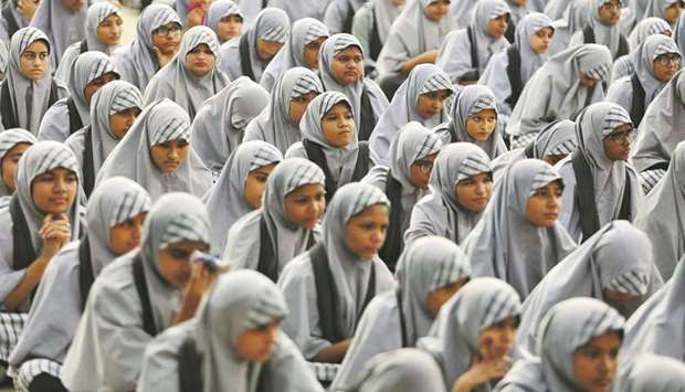 Schoolgirls listen to their teacher during a lecture on the Article 370, a special constitutional status for Kashmir which was scrapped by the government last month, at a school in Ahmedabad yesterday.