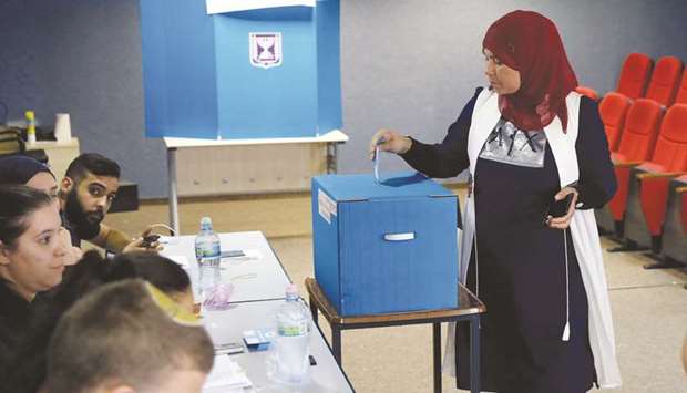 An Arab Israeli woman votes during Israelu2019s parliamentary election at a polling station in Kafr Manda near Haifa yesterday.