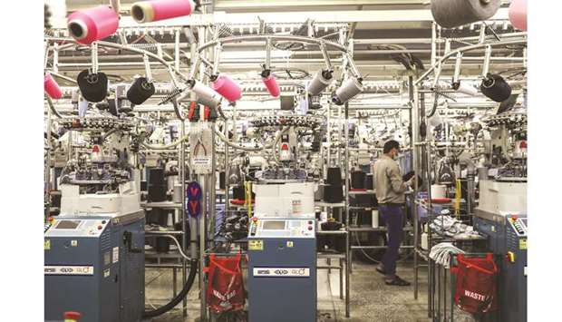 An employee monitors machinery in the knitting section of an Interloop Ltd facility in Faisalabad, Pakistan. The International Monetary Fund has ruled out any revision in its programme targets with Pakistan and generally appreciated the progress shown by the authorities towards stabilisation of macroeconomic indicators and their initial encouraging results.