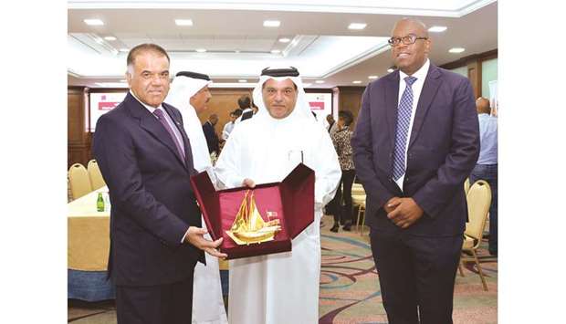 Qatar Chamber board member Mohamed bin Ahmed al-Obaidli hands over a token of recognition to South African ambassador Faizal Mooza after a business meeting between Qatari private sector stakeholders and a delegation led by Harold Manamela of South Africau2019s Department of Trade and Industry.