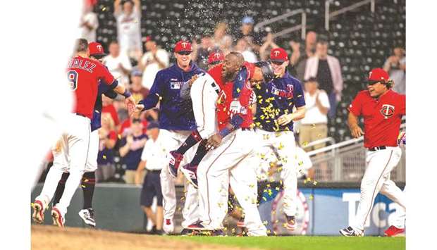 Minnesota Twins second baseman Ronald Torreyes celebrates with teammates after a walk off hit by pitch with the bases loaded during the 12th inning against the Chicago White Sox at Target Field. PICTURE: USA TODAY Sports