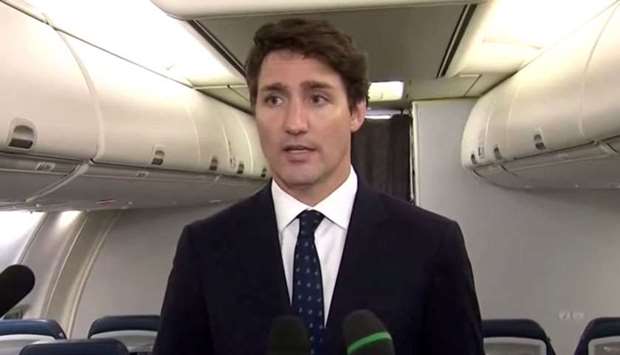 Canadau2019s Prime Minister Justin Trudeau apologizes for wearing brownface makeup in 2001, to reporters on the Liberal party leaderu2019s election campaign jet in Halifax