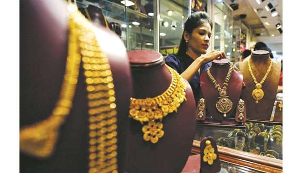A salesperson is seen inside a jewellery showroom in Mumbai. Spot gold was up 0.6% at $1,502.53 per ounce, after falling on Wednesday to $1,484.16, a one-week low.