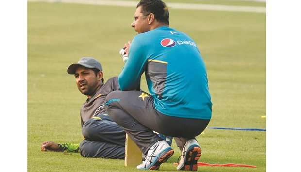 Pakistan captain Sarfraz Ahmed (left) and team bowling coach Waqar Younis take a break during a training session at the Gaddafi Cricket Stadium in Lahore yesterday. (AFP)