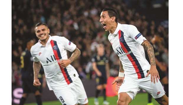 Paris Saint-Germainu2019s Angel Di Maria (right) celebrates scoring a goal during the UEFA Champions League Group A match against Real Madrid at the Parc des Princes stadium in Paris, France, yesterday. (AFP)