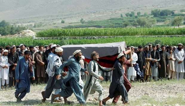 Men carry a coffin of one of the victims after a drone strike, yesterday in Khogyani district of Nangarhar province, Afghanistan