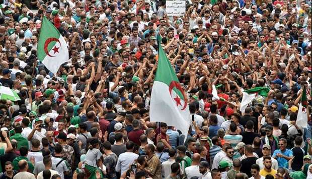 Algerian protesters take part in a demonstration against the country's army chief in Algeria's capital Algiers