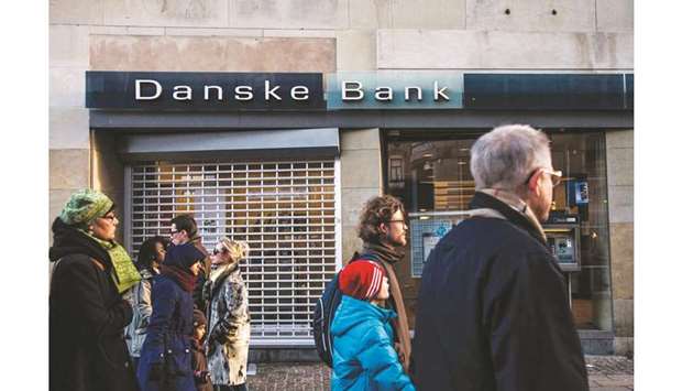 Pedestrians pass a Danske Bank branch in Copenhagen. Danske is racing ahead of its rivals in issuing a key type of debt as investors desperate for yield look past the lenderu2019s history of financial scandal.