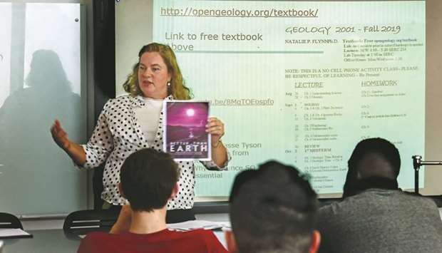 Temple University physical geology professor Natalie Flynn talks to her students about using a free website (on smart board) instead of a textbook, on the first day of class on August 26, 2019. She is using open resource materials in the classroom as part of a program at Temple that encourages professors to write their own textbooks or use other free resources so students donu2019t have to buy expensive textbooks.