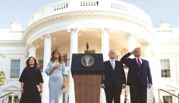 US President Donald Trump, First Lady Melania Trump, Australian Prime Minister Scott Morrison and his wife, Jennifer Morrison, stand for the National Anthems during an arrival ceremony for an Official Visit on the South Lawn of the White House in Washington, DC, yesterday.