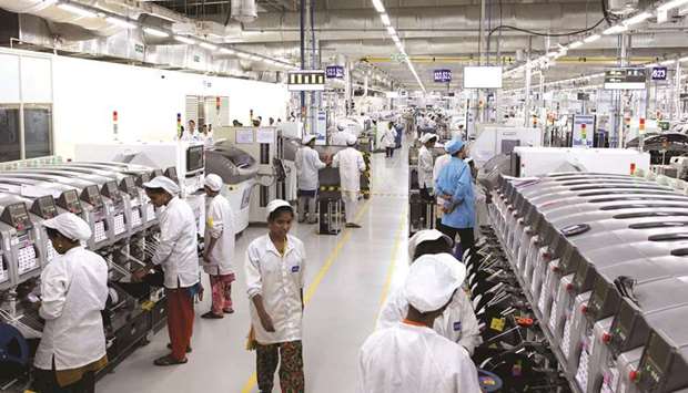 Employees work on an assembly line in the mobile phone plant of Rising Stars Mobile India Pvt, a unit of Foxconn Technology, in Sriperumbudur, Tamil Nadu. Foxconnu2019s plant employs almost 15,000 workers u2013 about 90% of them women u2013 and assembles phones for various manufacturers, including local best-seller Xiaomi.