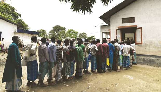 People stand in a queue to check their names on the final list of the National Register of Citizens (NRC) in an office in Pavakati village of Morigoan district, some 70km from Guwahati.