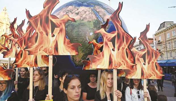 Students and activists hold up a globe during the global climate action march in Zagreb, Croatia.
