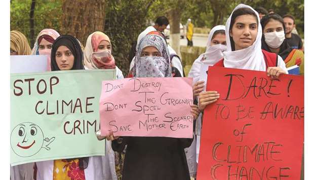 Students hold placards as they march in Peshawar to protest governmental inaction towards climate breakdown and environmental pollution, as part of demonstrations being held worldwide in a movement dubbed u2018Fridays for Futureu2019.