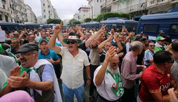 Demonstrators shout slogans during a protest to reject the Algerian election announcement for December, in Algiers, yesterday.