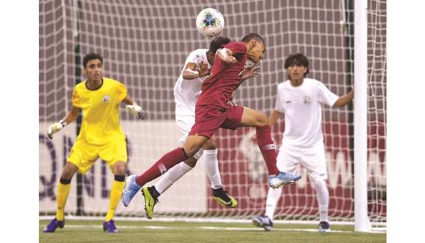 Qatar and Yemen players battle for the ball during the Asian U-16 Championship qualifiers at the Aspire Dome Indoor Stadium.