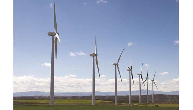 Turbines stand in a line at the Vedadillo wind energy farm operated by Acciona in Navarra, Spain (file). On sun-drenched fields across Spain and Italy, developers are building solar farms without subsidies or tax-breaks, betting they can profit without them.