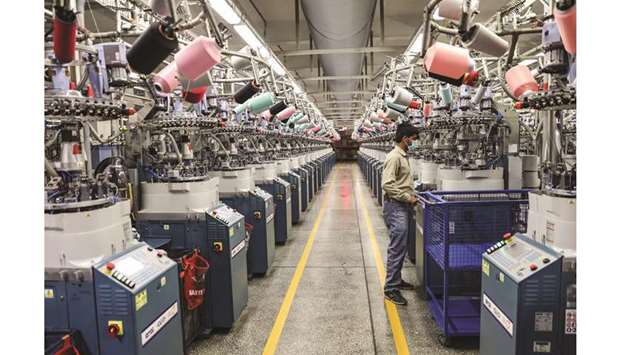 An employee monitors machinery in the knitting section of an Interloop Ltd facility in Faisalabad. Pakistanu2019s knitwear exports increased 12.84% to $541.484mn in the July-August period.