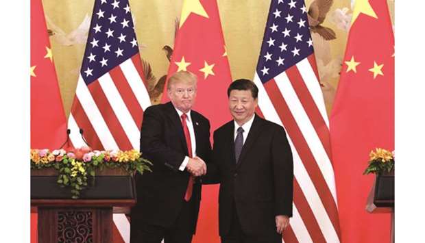 US President Donald Trump and Chinese President Xi Jinping at a meeting in Beijing (file). The tariffs Trump added this month on China are set to bite and his administration is preparing to pile on yet more duties in October, and more again in December if there is no breakthrough in the negotiations.