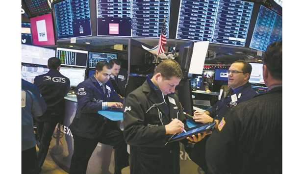 Traders work on the floor of the New York Stock Exchange (file). A profit warning and muted outlook from package delivery company FedEx Corp is prompting some high-profile fund managers on Wall Street to prepare for the trade war between the United States and China to last longer than many had originally anticipated.