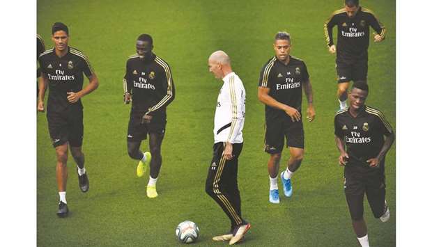 Real Madridu2019s coach Zinedine Zidane (centre) and players attend a training session in Madrid yesterday. (AFP)