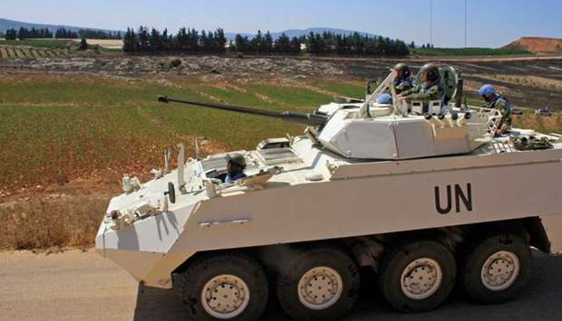 Irish soldiers of the United Nations Interim Forces in Lebanon (UNIFIL) patrol a road in the southern Lebanese village of Maroun al-Ras along the border with Israel