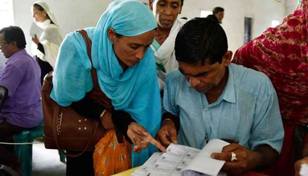 People check their names on the final list of the National Register of Citizens (NRC) at Buraburi village in Morigaon district of Assam