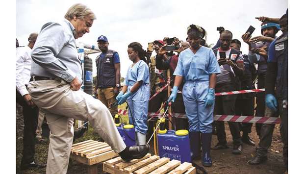 An Ebola response team disinfects the shoes of United Nation Secretary-General Antonio Guterres on his arrival at an Ebola treatment centre in Mangina, North Kivu province.