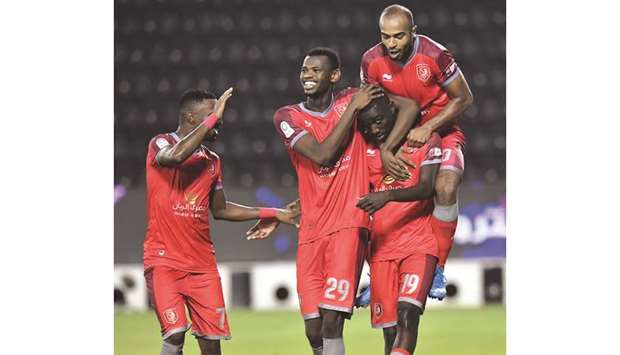Al Duhailu2019s Mohamed Muntari (second from left) and Almoez Ali (second from right) celebrate a goal during the QNB Stars League match against Al Wakrah yesterday. PICTURE: Noushad Thekkayil