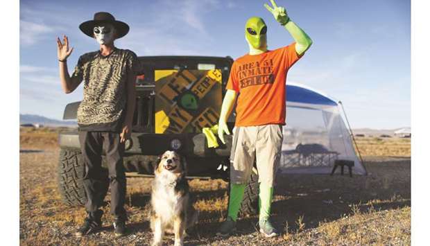 Revellers pose at the u2018Storm Area 51u2019 spinoff event u2018Alienstocku2019 on Friday in Rachel, Nevada. The event was a spinoff from the original u2018Storm Area 51u2019 Facebook event which jokingly encouraged participants to charge the famously secretive Area 51 military base in order to u2018see them aliensu2019.