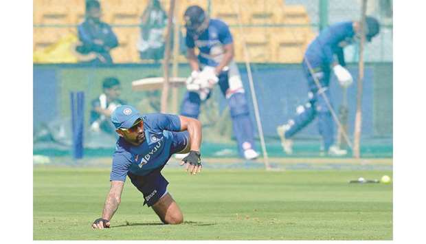 Indiau2019s Shikhar Dhawan dives to stop a ball during a practice session at the M. Chinnaswamy Stadium in Bengaluru yesterday. (AFP)