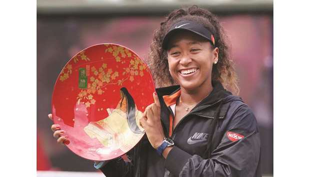 Naomi Osaka celebrates with victory plate after winning Pan Pacific Open in Osaka yesterday. (AFP)