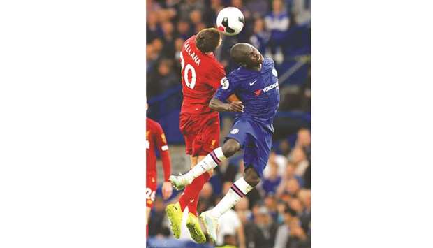 Liverpoolu2019s Adam Lallana (left) and Chelseau2019s Nu2019Golo Kante go for a header during the English Premier League match in London yesterday. (AFP)