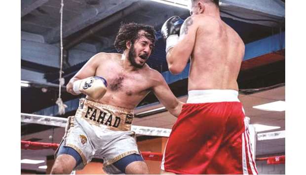 Qatari boxer Sheikh Fahad bin Khalid al-Thani (left) lands a punch on Romaniau2019s Ionut Bogheanu during their bout in Madrid, Spain, on Saturday.