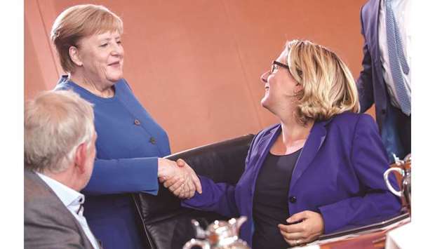 This picture taken on Friday shows Merkel greeting Schulze ahead a climate cabinet meeting in Berlin.