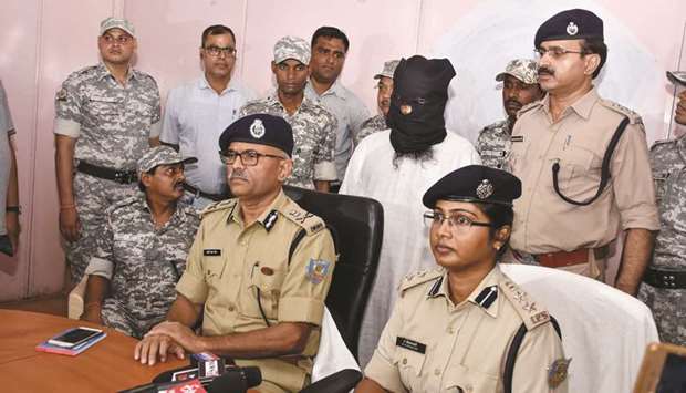 Al Qaedau2019s militant Mohamed Kalimuddin Mujahiri is guarded by security personnel as senior police officers address a press conference in Ranchi in Jharkhand yesterday.