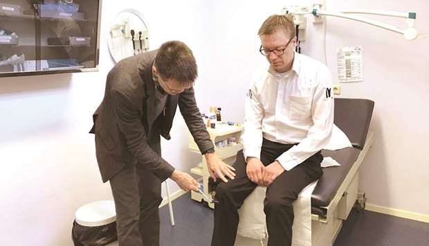Dr Jako Burkers, a Dutch family physician, examines Erik Eikelenstam at his offices in Gorinchem, a small city south of Amsterdam. Eikelstam, a restaurant manager who had lower back pain, paid nothing for the visit because all primary care visits in the Netherlands are free of charge for patients to discourage patients from skipping medical.