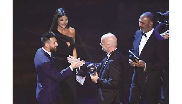 FIFA President Gianni Infantino presents FC Barcelonau2019s Lionel Messi  (L) with the Best FIFA Menu2019s player award as presenters Ilaria Du2019Amico and Ruud Gullit look on in Milan yesterday.