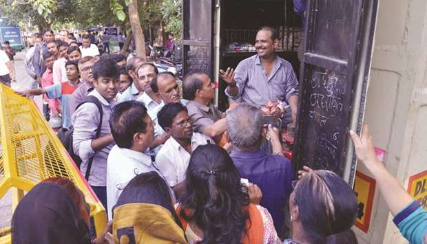 People queue up to buy onions at a stall put up by the National Co-operative Consumersu2019 Federation of India in front of Agriculture Ministry in New Delhiu2019s Central Secretariat area, yesterday.