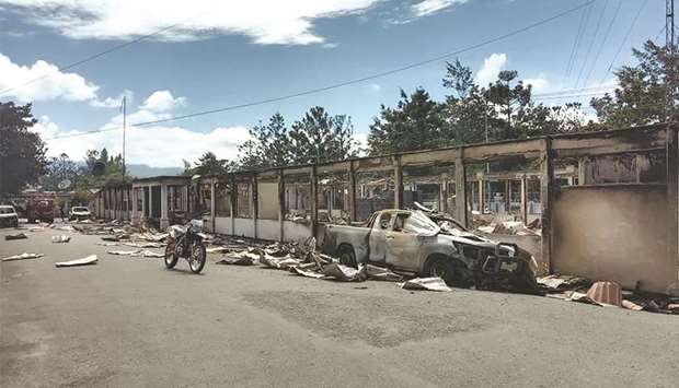 Burnt out shops are pictured along a street in Wamena yesterday, where hundreds had demonstrated and burned down a government office and other buildings the day before.