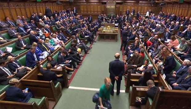 A video grab from footage broadcast by the UK Parliament's Parliamentary Recording Unit (PRU) shows members of parliament gathering in the House of Commons in central London