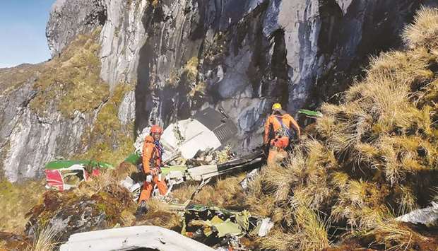 Indonesiau2019s Timika search and rescue team (Basarnas Timika) evacuating victims from the site of a DHC-6 Twin Otter air crash along a steep cliff in Ilaga, in Papua province yesterday.