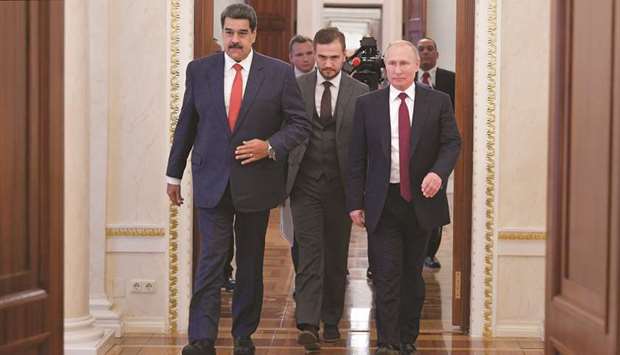Russian President Vladimir Putin and his Venezuelan counterpart Nicolas Maduro enter a hall during their meeting in Moscow, Russia, yesterday.
