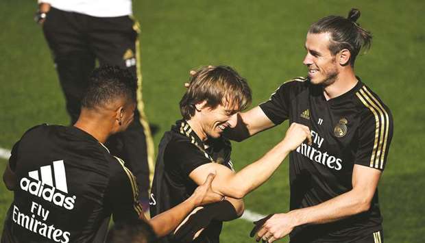 Real Madridu2019s Casemiro (left), Luka Modric (centre) and Gareth Bale joke around during a training session in Madrid. (AFP)
